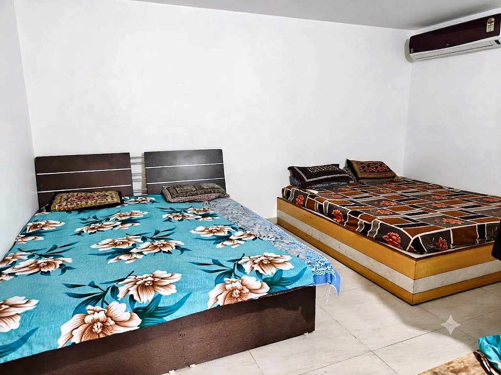 Four sharing room with double beds for boys at Shivam PG Bopal, Ahmedabad